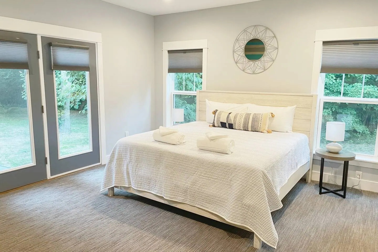 Upstairs bedroom with a king bed and double glass doors